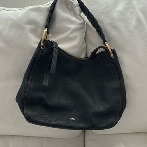 Furla black pebble leather shoulder bag with braided handle.